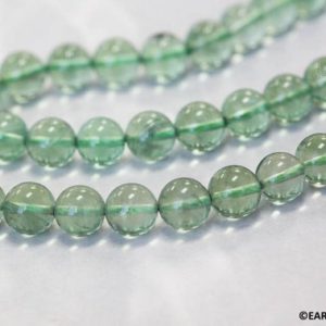 Shop Fluorite Round Beads! M/ Green Fluorite 10mm Smooth Round beads 15.5" strand Transparent green for jewelry making | Natural genuine round Fluorite beads for beading and jewelry making.  #jewelry #beads #beadedjewelry #diyjewelry #jewelrymaking #beadstore #beading #affiliate #ad