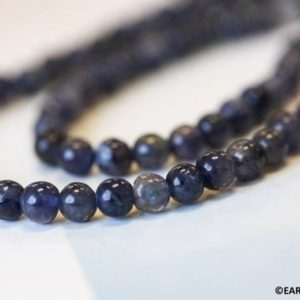 Shop Iolite Round Beads! S/ Iolite 6.5-7mm Off-Round beads 14" strand Size varies Blue gemstone beads For jewelry making | Natural genuine round Iolite beads for beading and jewelry making.  #jewelry #beads #beadedjewelry #diyjewelry #jewelrymaking #beadstore #beading #affiliate #ad