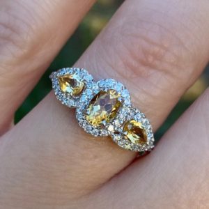 Shop Citrine Engagement Rings! Oval Citrine 3 stone diamond halo statement ring. Citrine engagement ring. Birthstone ring. Anniversary gift. | Natural genuine Citrine rings, simple unique alternative gemstone engagement rings. #rings #jewelry #bridal #wedding #jewelryaccessories #engagementrings #weddingideas #affiliate #ad