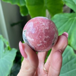 Shop Rhodochrosite Shapes! Rhodochrosite sphere, Argentina | Natural genuine stones & crystals in various shapes & sizes. Buy raw cut, tumbled, or polished gemstones for making jewelry or crystal healing energy vibration raising reiki stones. #crystals #gemstones #crystalhealing #crystalsandgemstones #energyhealing #affiliate #ad