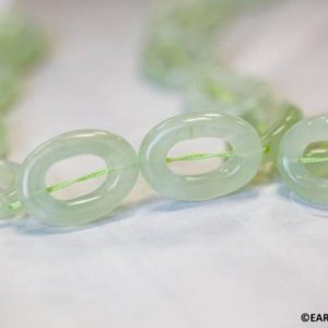 Shop Serpentine Beads! L/ New Jade 18x25mm Twist Oval Donut beads 16" strand Natural light green serpentine beads Shade varies for jewelry making | Natural genuine beads Serpentine beads for beading and jewelry making.  #jewelry #beads #beadedjewelry #diyjewelry #jewelrymaking #beadstore #beading #affiliate #ad
