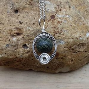 Green Serpentine pendant. 'Serpent rock'. Reiki jewelry uk. Silver plated Wire wrapped pendant. 10mm stone. Oval frame necklace | Natural genuine Serpentine pendants. Buy crystal jewelry, handmade handcrafted artisan jewelry for women.  Unique handmade gift ideas. #jewelry #beadedpendants #beadedjewelry #gift #shopping #handmadejewelry #fashion #style #product #pendants #affiliate #ad