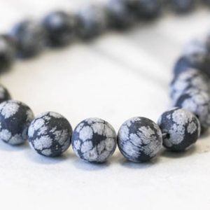 Shop Snowflake Obsidian Round Beads! M/ Snowflake Obsidian 12mm/ 10mm Round Beads Matte Finish 16" Strand Natural Black/Gray gemstone Beads For Jewelry Making | Natural genuine round Snowflake Obsidian beads for beading and jewelry making.  #jewelry #beads #beadedjewelry #diyjewelry #jewelrymaking #beadstore #beading #affiliate #ad