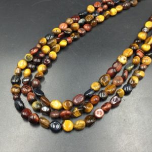 Shop Tiger Eye Chip & Nugget Beads! Tiger Eye Pebble Beads Polished Brown Tiger Eye Beads 6-8mm Natural Tiger Stone Nugget Beads Gemstone Crystal Beads 15.5" Strand | Natural genuine chip Tiger Eye beads for beading and jewelry making.  #jewelry #beads #beadedjewelry #diyjewelry #jewelrymaking #beadstore #beading #affiliate #ad