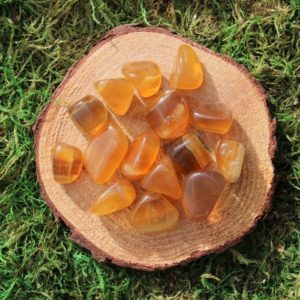 Shop Tumbled Fluorite Crystals & Pocket Stones! Dark Yellow Fluorite Tumbled Medium Size | Natural genuine stones & crystals in various shapes & sizes. Buy raw cut, tumbled, or polished gemstones for making jewelry or crystal healing energy vibration raising reiki stones. #crystals #gemstones #crystalhealing #crystalsandgemstones #energyhealing #affiliate #ad