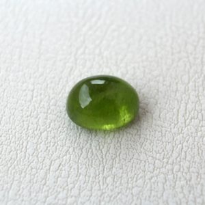 Shop Peridot Stones & Crystals! Loose Peridot oval cabochon gemstone 12x9mm Natural stone for jewelry 7.05ct | Natural genuine stones & crystals in various shapes & sizes. Buy raw cut, tumbled, or polished gemstones for making jewelry or crystal healing energy vibration raising reiki stones. #crystals #gemstones #crystalhealing #crystalsandgemstones #energyhealing #affiliate #ad