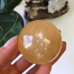 Shop Calcite Shapes! Honey Calcite Sphere with Rainbow inclusion, Top Quality Honey Calcite | Natural genuine stones & crystals in various shapes & sizes. Buy raw cut, tumbled, or polished gemstones for making jewelry or crystal healing energy vibration raising reiki stones. #crystals #gemstones #crystalhealing #crystalsandgemstones #energyhealing #affiliate #ad