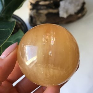 Shop Calcite Shapes! Honey Calcite Sphere with Rainbow inclusion, Top Quality Honey Calcite | Natural genuine stones & crystals in various shapes & sizes. Buy raw cut, tumbled, or polished gemstones for making jewelry or crystal healing energy vibration raising reiki stones. #crystals #gemstones #crystalhealing #crystalsandgemstones #energyhealing #affiliate #ad