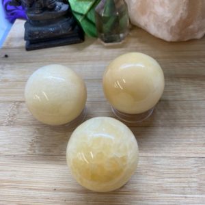 Shop Calcite Stones & Crystals! Yellow Calcite sphere crystal ball Shelf 8 | Natural genuine stones & crystals in various shapes & sizes. Buy raw cut, tumbled, or polished gemstones for making jewelry or crystal healing energy vibration raising reiki stones. #crystals #gemstones #crystalhealing #crystalsandgemstones #energyhealing #affiliate #ad