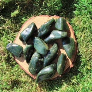 Shop Tumbled Jade Crystals & Pocket Stones! Dark Oblong Pieces of Nephrite Jade Tumbled | Natural genuine stones & crystals in various shapes & sizes. Buy raw cut, tumbled, or polished gemstones for making jewelry or crystal healing energy vibration raising reiki stones. #crystals #gemstones #crystalhealing #crystalsandgemstones #energyhealing #affiliate #ad