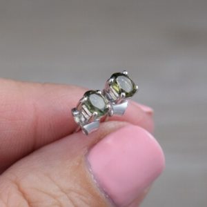 Moldavite Stud Earrings (Sterling Silver) – Green – Genuine Faceted Gemstone Studs – 5 x 4 mm Oval | Natural genuine Moldavite earrings. Buy crystal jewelry, handmade handcrafted artisan jewelry for women.  Unique handmade gift ideas. #jewelry #beadedearrings #beadedjewelry #gift #shopping #handmadejewelry #fashion #style #product #earrings #affiliate #ad
