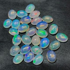Shop Opal Cabochons! AAA Grade Ethiopian Opal, 5 or 10 piece lot  Natural Ethiopian Opal Cabochon size Available 3×5. 4×6 ,6×8 , 7×9, 8×10 MM Jewelry Making | Natural genuine stones & crystals in various shapes & sizes. Buy raw cut, tumbled, or polished gemstones for making jewelry or crystal healing energy vibration raising reiki stones. #crystals #gemstones #crystalhealing #crystalsandgemstones #energyhealing #affiliate #ad