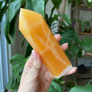 Shop Orange Calcite Points & Wands! Orange calcite tower | Natural genuine stones & crystals in various shapes & sizes. Buy raw cut, tumbled, or polished gemstones for making jewelry or crystal healing energy vibration raising reiki stones. #crystals #gemstones #crystalhealing #crystalsandgemstones #energyhealing #affiliate #ad