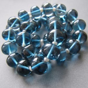 Shop Topaz Rondelle Beads! London blue topaz rondelles • 10x8mm • Limited stock • AAA+ smooth polished • Natural gemstone • Deep water Ocean blue • Personal Favourite | Natural genuine rondelle Topaz beads for beading and jewelry making.  #jewelry #beads #beadedjewelry #diyjewelry #jewelrymaking #beadstore #beading #affiliate #ad