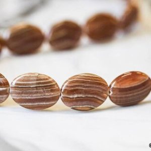 Shop Rhodochrosite Bead Shapes! L/ Brown Rhodochrosite 15x20mm Flat Oval Beads 16" Strand Natural Genuine Brown Stripe Rhodochrosite Flat Oval For Crafts For Jewelry Making | Natural genuine other-shape Rhodochrosite beads for beading and jewelry making.  #jewelry #beads #beadedjewelry #diyjewelry #jewelrymaking #beadstore #beading #affiliate #ad