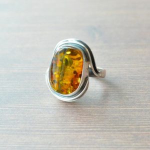 Shop Amber Jewelry! Silver Hugging Golden Amber Ring // Amber Jewelry // Sterling Silver // Village Silversmith | Natural genuine Amber jewelry. Buy crystal jewelry, handmade handcrafted artisan jewelry for women.  Unique handmade gift ideas. #jewelry #beadedjewelry #beadedjewelry #gift #shopping #handmadejewelry #fashion #style #product #jewelry #affiliate #ad