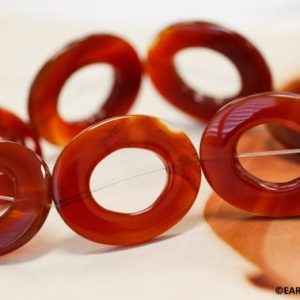 XL/ Carnelian 30x36mm Oval Donut beads 16" strand Dyed red carnelian gemstone beads Shade varies For jewelry making | Natural genuine beads Gemstone beads for beading and jewelry making.  #jewelry #beads #beadedjewelry #diyjewelry #jewelrymaking #beadstore #beading #affiliate #ad