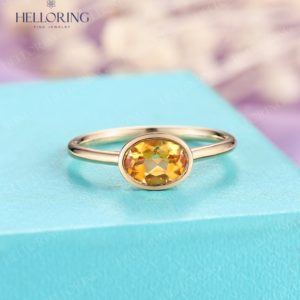 Oval citrine engagement ring solid gold ring Solitaire ring Vintage ring yellow citrine minimalist ring simple bezel set ring | Natural genuine Gemstone rings, simple unique alternative gemstone engagement rings. #rings #jewelry #bridal #wedding #jewelryaccessories #engagementrings #weddingideas #affiliate #ad