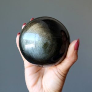 Shop Golden Obsidian Stones & Crystals! Gold Sheen Obsidian Sphere Shiny Prosperity Protection Crystal Ball | Natural genuine stones & crystals in various shapes & sizes. Buy raw cut, tumbled, or polished gemstones for making jewelry or crystal healing energy vibration raising reiki stones. #crystals #gemstones #crystalhealing #crystalsandgemstones #energyhealing #affiliate #ad