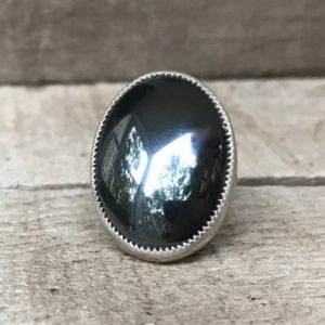 Shop Hematite Jewelry! Large Oval Gray Reflective Hematite Serrated Setting Sterling Silver Ring | Boho | Rocker | Edgy | Hematite Ring | Gifts for Her | Natural genuine Hematite jewelry. Buy crystal jewelry, handmade handcrafted artisan jewelry for women.  Unique handmade gift ideas. #jewelry #beadedjewelry #beadedjewelry #gift #shopping #handmadejewelry #fashion #style #product #jewelry #affiliate #ad