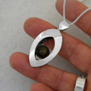 Shop Golden Obsidian Pendants! Lanceolate pendant made of silver with a golden obsidian gemstone. Pendant with volume. Architectural structural pendant. Golden obsidian | Natural genuine Golden Obsidian pendants. Buy crystal jewelry, handmade handcrafted artisan jewelry for women.  Unique handmade gift ideas. #jewelry #beadedpendants #beadedjewelry #gift #shopping #handmadejewelry #fashion #style #product #pendants #affiliate #ad