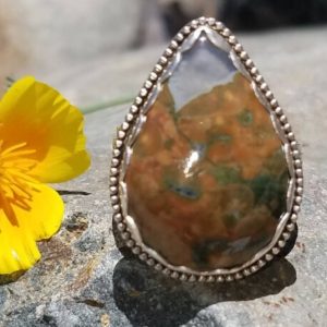Shop Rainforest Jasper Rings! Rainforest Jasper Ring in sterling silver. Cabochon has a crystal intrusion. Heart-themed ring band. Made in California, USA Size US 10 1/2 | Natural genuine Rainforest Jasper rings, simple unique handcrafted gemstone rings. #rings #jewelry #shopping #gift #handmade #fashion #style #affiliate #ad