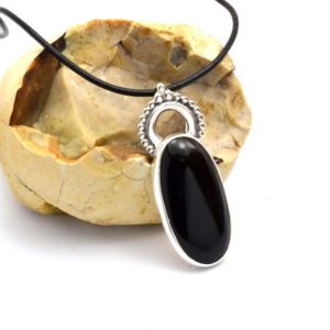 Shop Onyx Pendants! Black onyx pendant in sterling silver, oval black stone on leather cord necklace, Christmas gift for her | Natural genuine Onyx pendants. Buy crystal jewelry, handmade handcrafted artisan jewelry for women.  Unique handmade gift ideas. #jewelry #beadedpendants #beadedjewelry #gift #shopping #handmadejewelry #fashion #style #product #pendants #affiliate #ad