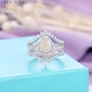 Shop Opal Rings! Vintage Opal engagement ring white gold Pear shaped wedding ring Diamond Moissanite ring Half eternity Twisted Bridal anniversary ring | Natural genuine Opal rings, simple unique alternative gemstone engagement rings. #rings #jewelry #bridal #wedding #jewelryaccessories #engagementrings #weddingideas #affiliate #ad