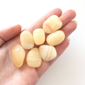 Shop Orange Calcite Stones & Crystals! Orange calcite smooth tumbled stone 15-20mm | Natural genuine stones & crystals in various shapes & sizes. Buy raw cut, tumbled, or polished gemstones for making jewelry or crystal healing energy vibration raising reiki stones. #crystals #gemstones #crystalhealing #crystalsandgemstones #energyhealing #affiliate #ad