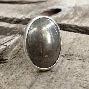 Shop Pyrite Jewelry! Boho Rocker Chic Large Minimalist Oval Golden Pyrite Sterling Silver Ring | Pyrite Ring | Statement Ring | Fools Gold Ring | Boho | Rocker | Natural genuine Pyrite jewelry. Buy crystal jewelry, handmade handcrafted artisan jewelry for women.  Unique handmade gift ideas. #jewelry #beadedjewelry #beadedjewelry #gift #shopping #handmadejewelry #fashion #style #product #jewelry #affiliate #ad