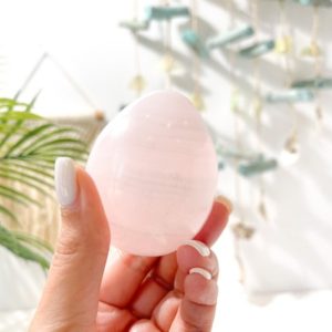 UV-Reactive Mangano Calcite Crystal Egg: Egg-cellent Addition to Your Crystal Collection | Natural genuine stones & crystals in various shapes & sizes. Buy raw cut, tumbled, or polished gemstones for making jewelry or crystal healing energy vibration raising reiki stones. #crystals #gemstones #crystalhealing #crystalsandgemstones #energyhealing #affiliate #ad