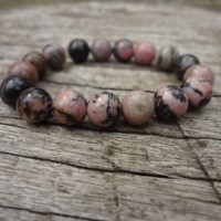 Pink And Black Rhodonite Bracelet. Musk Pink And Black Elastic Statement Bracelet Handmade By Miss Leroy | Natural genuine Gemstone jewelry. Buy crystal jewelry, handmade handcrafted artisan jewelry for women.  Unique handmade gift ideas. #jewelry #beadedjewelry #beadedjewelry #gift #shopping #handmadejewelry #fashion #style #product #jewelry #affiliate #ad