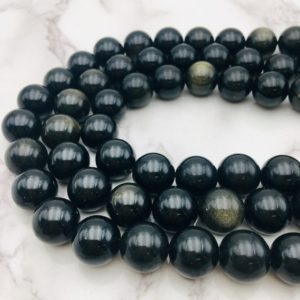 Shop Golden Obsidian Beads! Gold Obsidian Smooth Round Beads 14mm 16mm 15.5" Strand | Natural genuine round Golden Obsidian beads for beading and jewelry making.  #jewelry #beads #beadedjewelry #diyjewelry #jewelrymaking #beadstore #beading #affiliate #ad