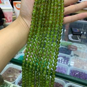 Shop Peridot Round Beads! AAA Peridot Round beads 4MM 6MM 8MM  High Quality Peridot Round Smooth Beads 15.5" Full Strand | Natural genuine round Peridot beads for beading and jewelry making.  #jewelry #beads #beadedjewelry #diyjewelry #jewelrymaking #beadstore #beading #affiliate #ad