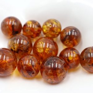 Shop Amber Round Beads! Baltic Amber Round Beads from 10 mm to 13 mm size, Drilled | Light Cognac Color Amber Stones | Natural genuine round Amber beads for beading and jewelry making.  #jewelry #beads #beadedjewelry #diyjewelry #jewelrymaking #beadstore #beading #affiliate #ad