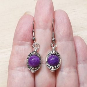 Shop Sugilite Earrings! Small Rare purple Sugilite earrings. Crystal Reiki jewelry uk. Silver plated Oval frame dangle drop earrings. 8mm stones | Natural genuine Sugilite earrings. Buy crystal jewelry, handmade handcrafted artisan jewelry for women.  Unique handmade gift ideas. #jewelry #beadedearrings #beadedjewelry #gift #shopping #handmadejewelry #fashion #style #product #earrings #affiliate #ad