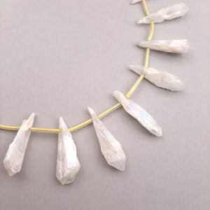 Shop Angel Aura Quartz Beads! White Aura Rough Quartz Nugget Points, Top Drilled Wolf Tooth Crystals, Rough Quartz Points, Teardrop Rock Crystal, Top Drilled Beads | Natural genuine other-shape Angel Aura Quartz beads for beading and jewelry making.  #jewelry #beads #beadedjewelry #diyjewelry #jewelrymaking #beadstore #beading #affiliate #ad