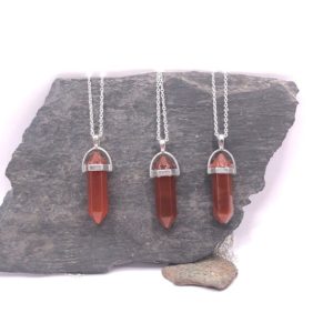 Shop Carnelian Jewelry! Carnelian point wand (confidence stone) crystal necklace silver / black cord / snake chain | Natural genuine Carnelian jewelry. Buy crystal jewelry, handmade handcrafted artisan jewelry for women.  Unique handmade gift ideas. #jewelry #beadedjewelry #beadedjewelry #gift #shopping #handmadejewelry #fashion #style #product #jewelry #affiliate #ad