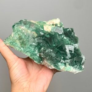 Shop Raw & Rough Fluorite Stones! Cubic green fluorite raw specimen color changing from Madagascar | Natural genuine stones & crystals in various shapes & sizes. Buy raw cut, tumbled, or polished gemstones for making jewelry or crystal healing energy vibration raising reiki stones. #crystals #gemstones #crystalhealing #crystalsandgemstones #energyhealing #affiliate #ad