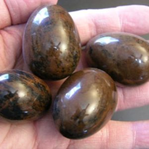 Shop Mahogany Obsidian Shapes! Mahogany obsidian egg hand carved polished 2 inch 1 egg w/ring stand per winner | Natural genuine stones & crystals in various shapes & sizes. Buy raw cut, tumbled, or polished gemstones for making jewelry or crystal healing energy vibration raising reiki stones. #crystals #gemstones #crystalhealing #crystalsandgemstones #energyhealing #affiliate #ad