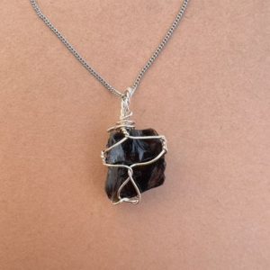 Shop Obsidian Necklaces! Natural Raw Obsidian Necklace | Elegantly Wire Wrapped with 925 Sterling Silver | Rough Obsidian Crystal Pendant | Natural Gemstone Jewelry | Natural genuine Obsidian necklaces. Buy crystal jewelry, handmade handcrafted artisan jewelry for women.  Unique handmade gift ideas. #jewelry #beadednecklaces #beadedjewelry #gift #shopping #handmadejewelry #fashion #style #product #necklaces #affiliate #ad