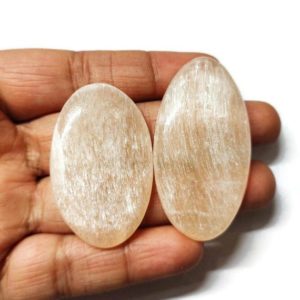 Shop Selenite Cabochons! Peach selenite cabochon, genuine AAA quality selenite loose gemstone flat back side, peach selenite cabochon 2 pieces set cabochon 49-43 mm | Natural genuine stones & crystals in various shapes & sizes. Buy raw cut, tumbled, or polished gemstones for making jewelry or crystal healing energy vibration raising reiki stones. #crystals #gemstones #crystalhealing #crystalsandgemstones #energyhealing #affiliate #ad