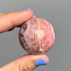 Shop Rhodochrosite Shapes! Rhodochrosite sphere with stand 35mm with hematite inclusions | Natural genuine stones & crystals in various shapes & sizes. Buy raw cut, tumbled, or polished gemstones for making jewelry or crystal healing energy vibration raising reiki stones. #crystals #gemstones #crystalhealing #crystalsandgemstones #energyhealing #affiliate #ad