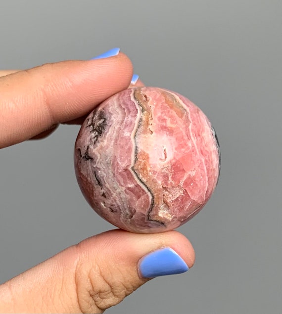 Rhodochrosite Sphere With Stand 35mm With Hematite Inclusions