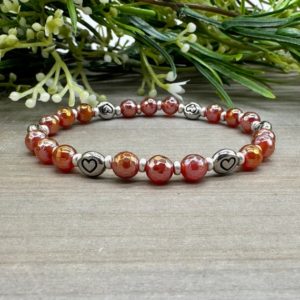 Shop Carnelian Bracelets! Courageous Heart Bracelet | Genuine Electroplated Faceted Carnelian Gemstone Bead Stretch Bracelet with Heart Accent Beads | Natural genuine Carnelian bracelets. Buy crystal jewelry, handmade handcrafted artisan jewelry for women.  Unique handmade gift ideas. #jewelry #beadedbracelets #beadedjewelry #gift #shopping #handmadejewelry #fashion #style #product #bracelets #affiliate #ad