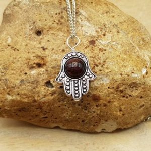 Shop Garnet Pendants! Garnet Hamsa pendant necklace. Dark red Crystal Reiki jewelry uk. January birthstone. Luck protection symbol. Empowered crystals | Natural genuine Garnet pendants. Buy crystal jewelry, handmade handcrafted artisan jewelry for women.  Unique handmade gift ideas. #jewelry #beadedpendants #beadedjewelry #gift #shopping #handmadejewelry #fashion #style #product #pendants #affiliate #ad
