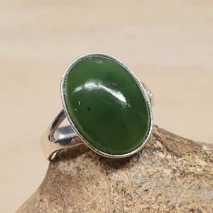 Shop Jade Rings! Simple oval Nephrite Jade ring. 925 sterling silver. Green Reiki jewelry. 12th anniversary gemstone. Women's Adjustable ring. 10x14mm stone | Natural genuine Jade rings, simple unique handcrafted gemstone rings. #rings #jewelry #shopping #gift #handmade #fashion #style #affiliate #ad