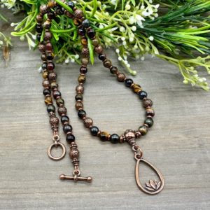 Shop Tiger Eye Pendants! Intuition and Integrity 20 inch Beaded Pendant | Multicolor Tiger Eye Genuine Crystal Gemstone and Copper Short Beaded Lotus Necklace | Natural genuine Tiger Eye pendants. Buy crystal jewelry, handmade handcrafted artisan jewelry for women.  Unique handmade gift ideas. #jewelry #beadedpendants #beadedjewelry #gift #shopping #handmadejewelry #fashion #style #product #pendants #affiliate #ad