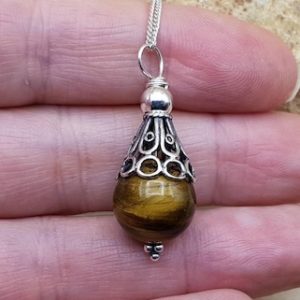 Shop Tiger Eye Pendants! Small Tigers eye pendant. Crystal Reiki jewelry. Capricorn jewelry uk. 12mm stone. Bali silver cone necklace. | Natural genuine Tiger Eye pendants. Buy crystal jewelry, handmade handcrafted artisan jewelry for women.  Unique handmade gift ideas. #jewelry #beadedpendants #beadedjewelry #gift #shopping #handmadejewelry #fashion #style #product #pendants #affiliate #ad