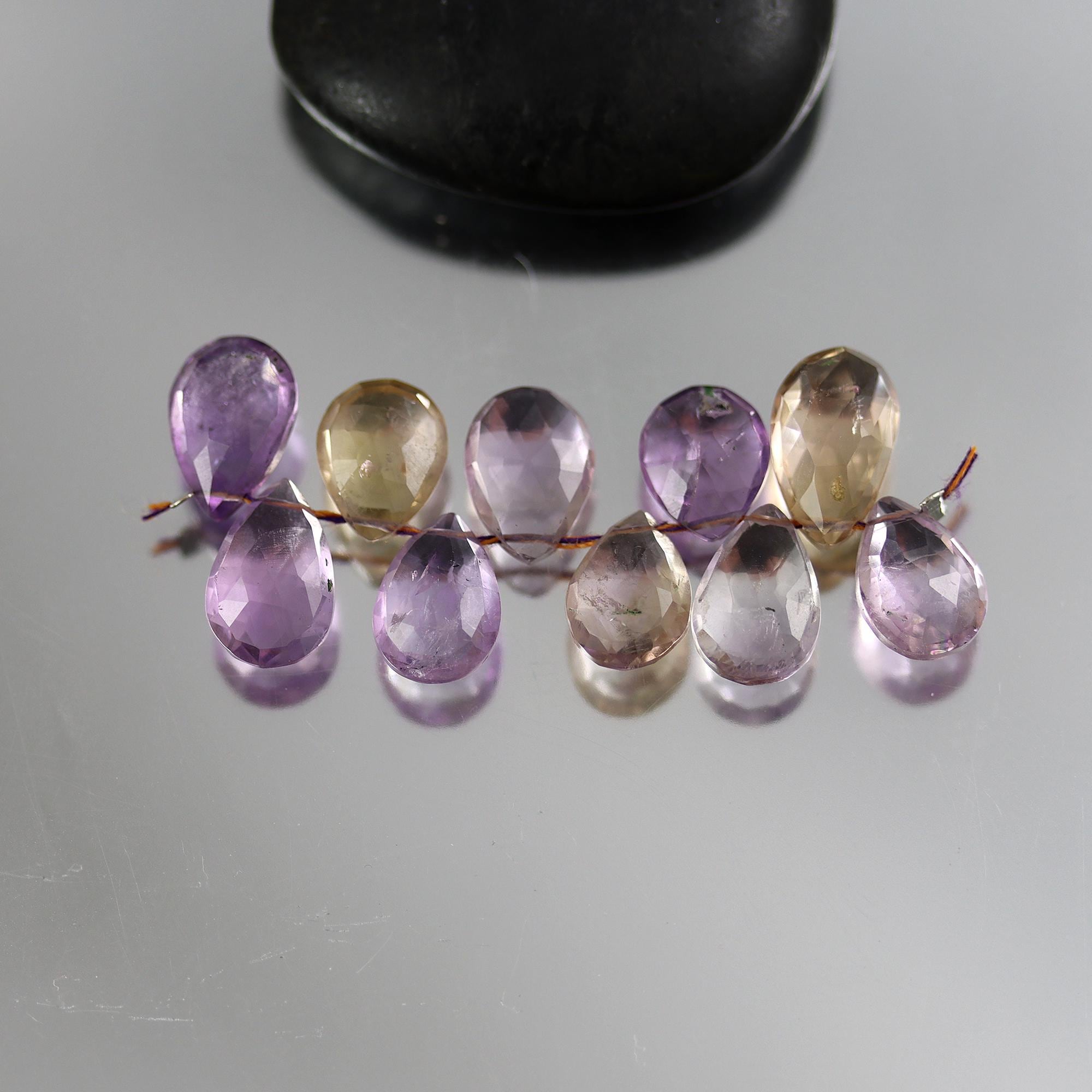 Faceted Ametrine Pear Briolette Beads - Set Of 10 (11-13mm) Faceted Ametrine Pear Briolette Beads - Set Of 10 (11-13mm)